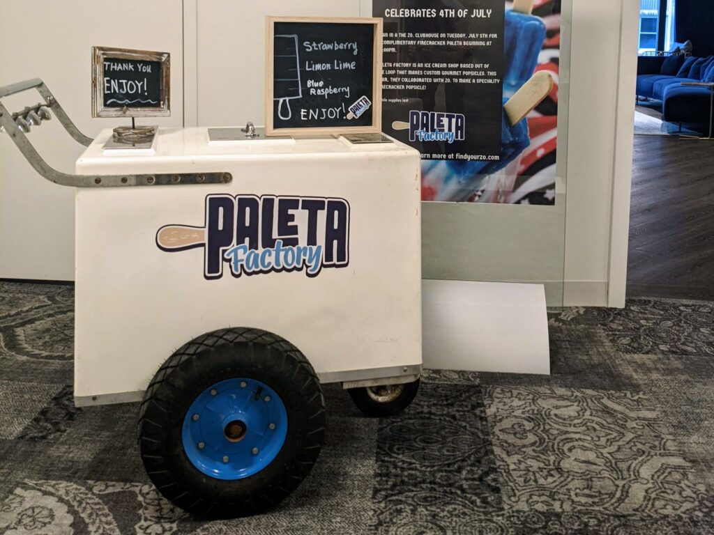 Paleta Factory cart offering custom gourmet paletas in strawberry, lime, and blue raspberry flavors for a 4th of July celebration.